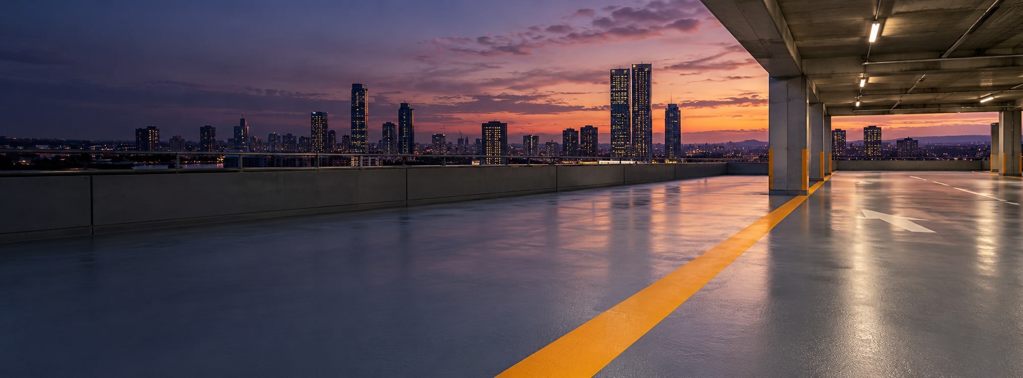 Illustrative exposed car park deck with grey resin finish and orange markings at dusk